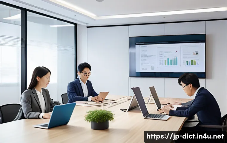 용어집 프로젝트 - A modern Japanese IT office scene showing a diverse team collaborating around a large table, with di...